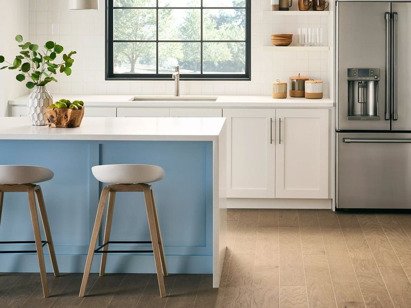 blue island kitchen table with white countertop and a brown hardwood floor from Floor Store and Design in Columbia, TN