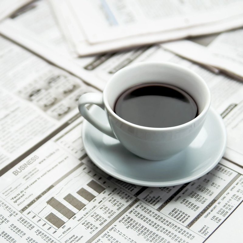 cup of coffee on a table full of newspaper in Columbia, TN